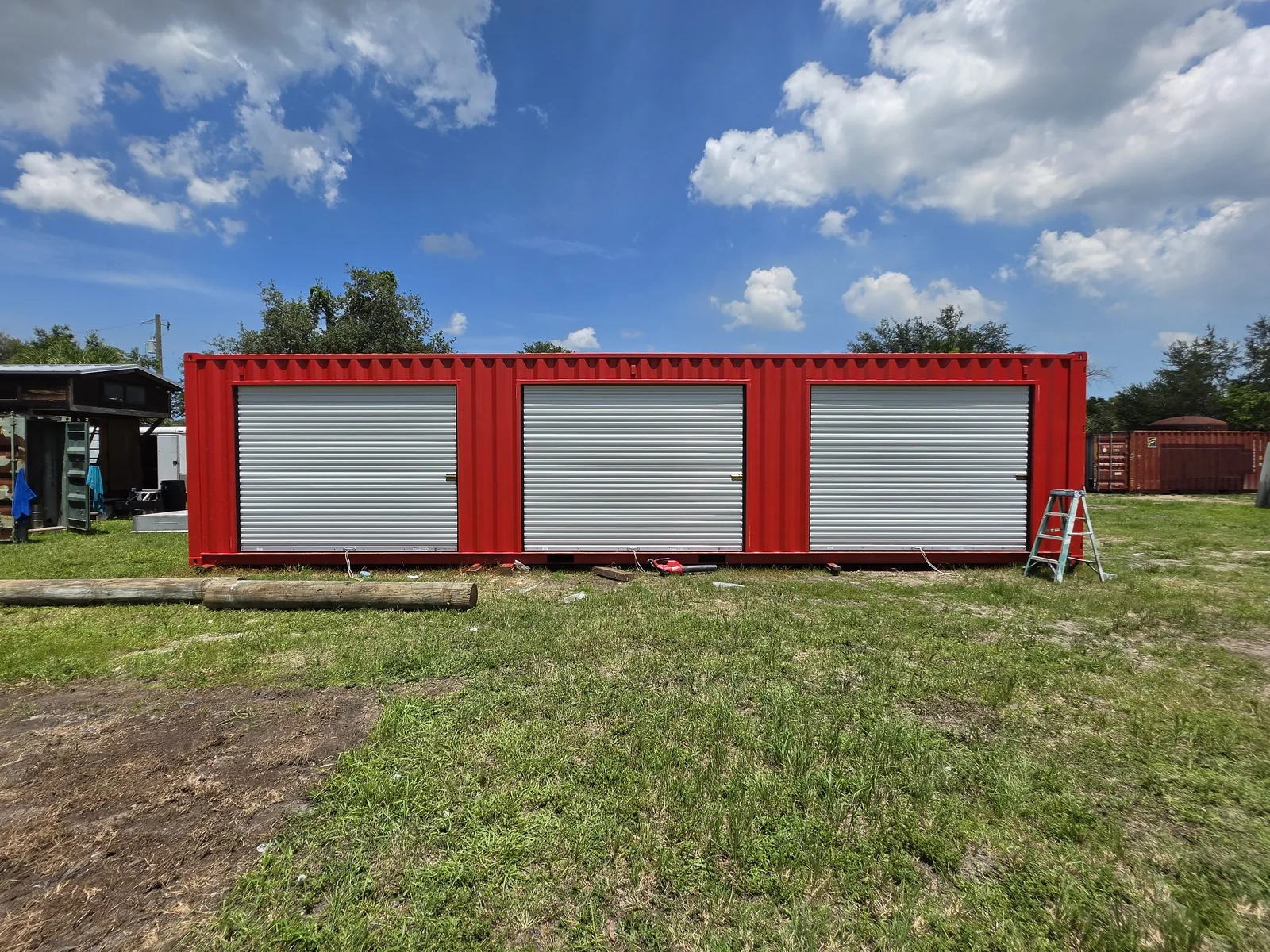 Red 40-foot high-cube container with three silver roll-up doors.
